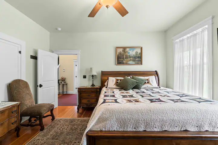 A bedroom with walls painted green